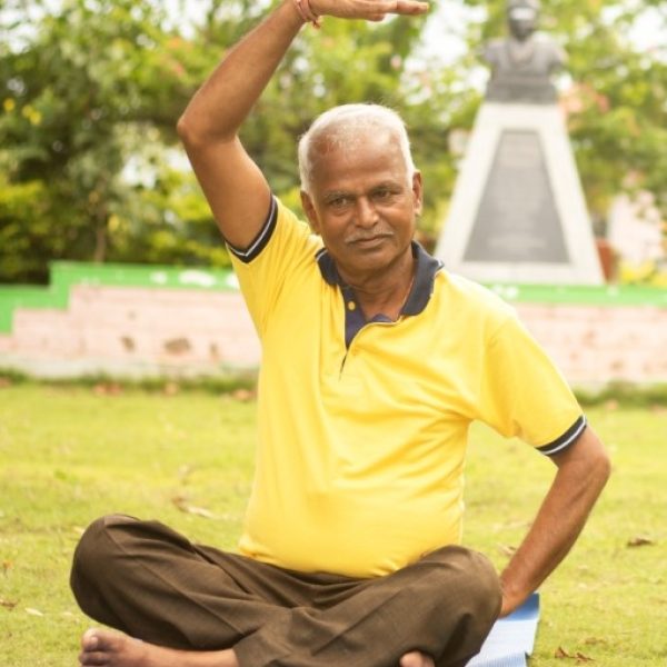 Happy senior people doing yoga by stretching hands - Concept of Senior people fitness and healthy lifestyle - two elderly man busy in morning exercise