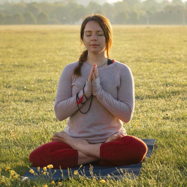 front-view-woman-meditating-outdoors-yoga-mat